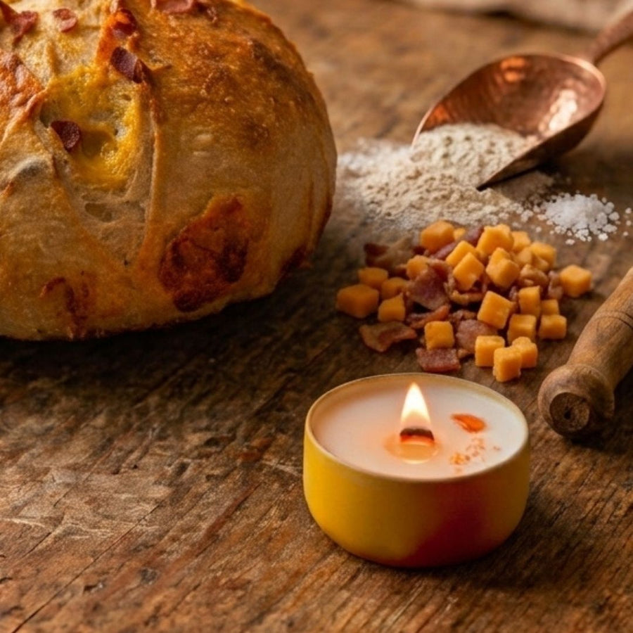 Warm artisan bread candle on  cozy kitchen counter with sourdough bread and cheddar cheese 