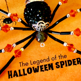 A Halloween spider craft or bead decoration with a black body, silver filigree headpiece, dark green bead, and orange-red faceted beads on black legs, shown on an orange textured background with the text 'The Legend of the HALLOWEEN SPIDER'.