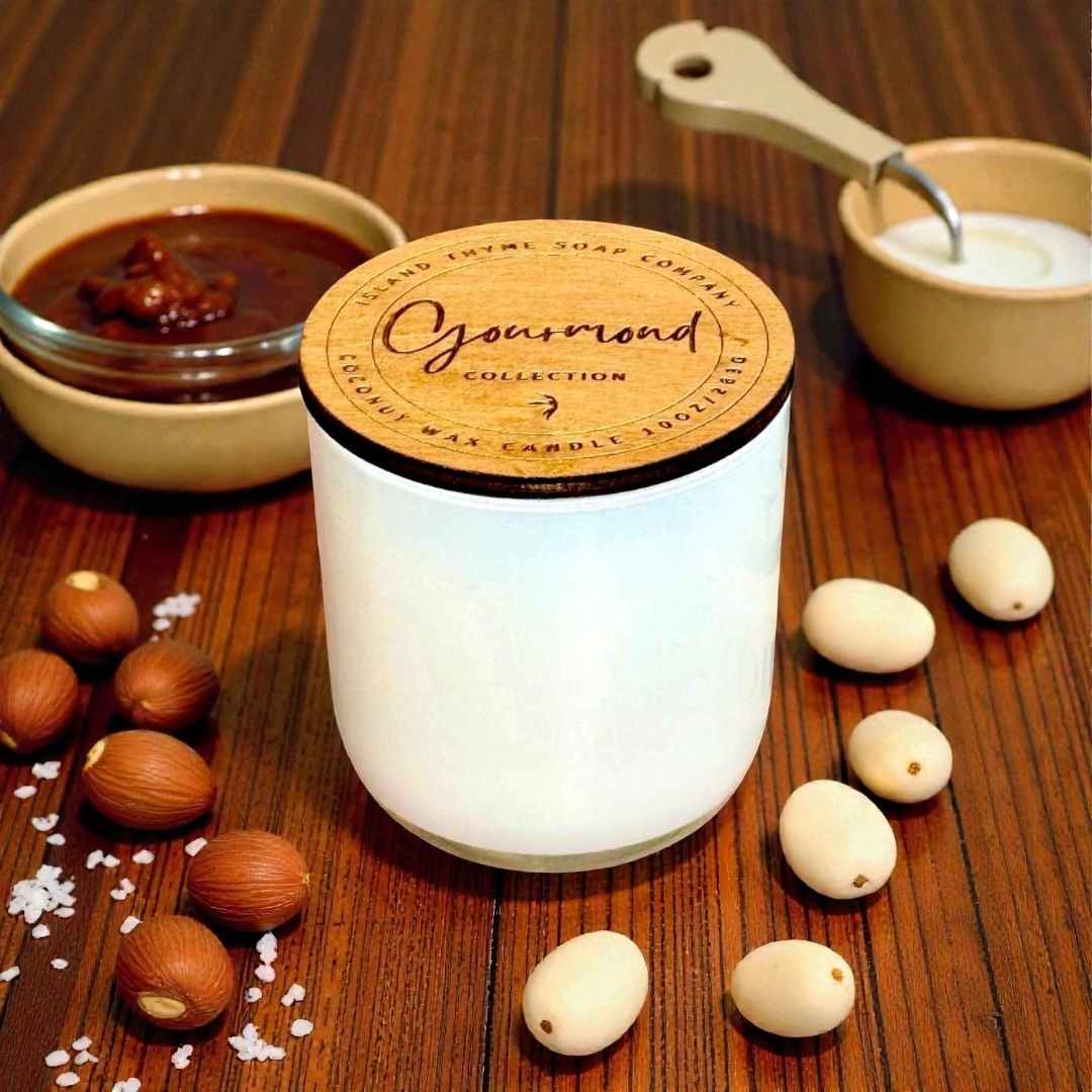 White candle with wooden lid on a wooden surface with nuts and salt